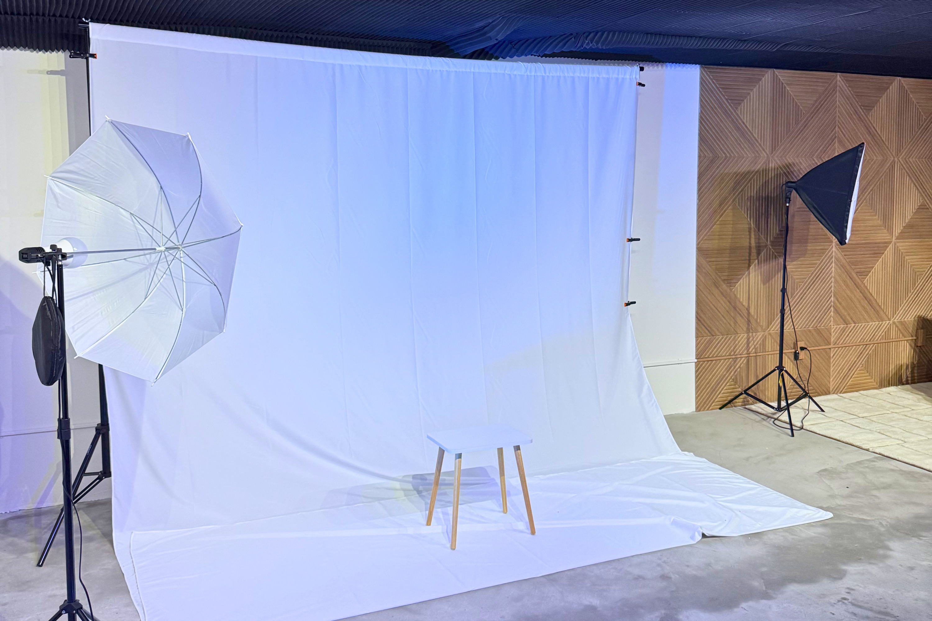 The Photography Studio — white backdrop, umbrella + softbox lighting